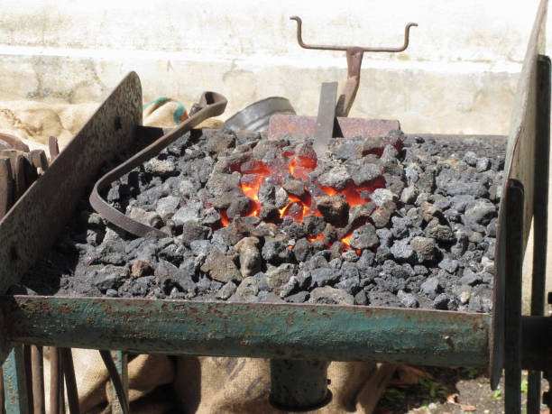 istock Old-fashioned blacksmith furnace with burning coals for iron work 678049810