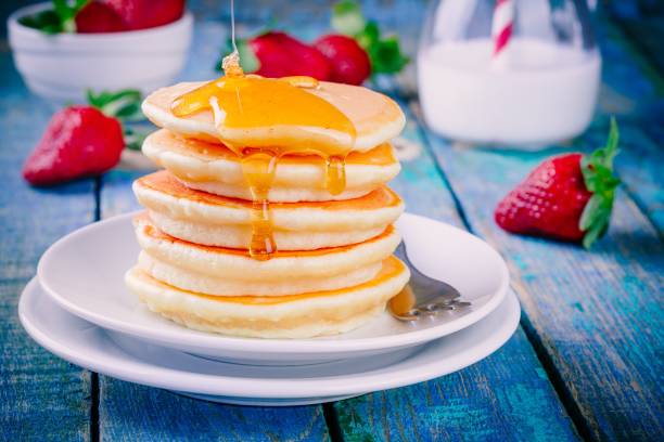 istock Homemade pancakes with honey and strawberries 678049852