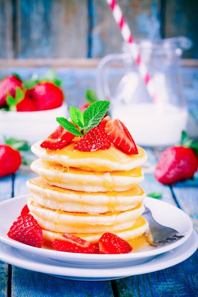 istock Homemade pancakes with honey and strawberries 678050072
