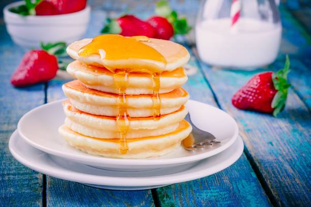 istock Homemade pancakes with honey and strawberries 678050146