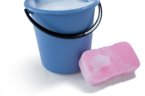 istock High angle view of sponge by bucket containing soap sud 678075494