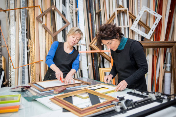 istock Restorer and framer laboratory craftswomen: Preparing frames 678075746