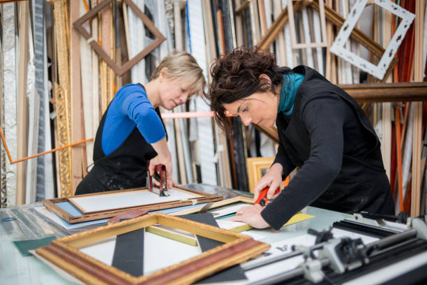 Restorer and framer laboratory craftswomen: Preparing frames