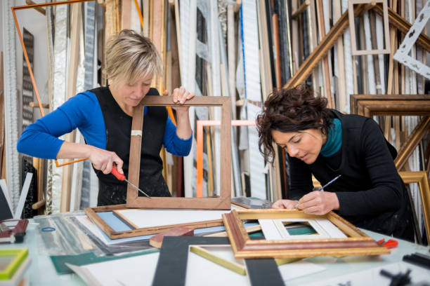 istock Restorer and framer laboratory craftswomen: Preparing frames 678076422