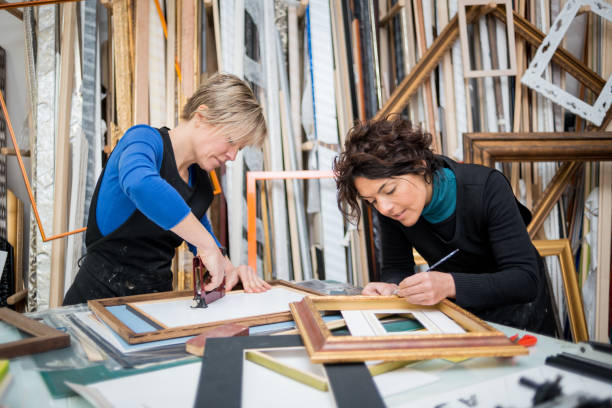 istock Restorer and framer laboratory craftswomen: Preparing frames 678076826