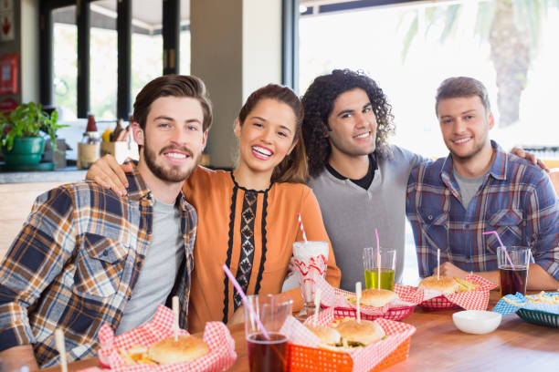 istock Cheerful friends sitting in restaurant 678077786