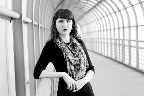 istock Young girl on the covered pedestrian bridge. 678078550