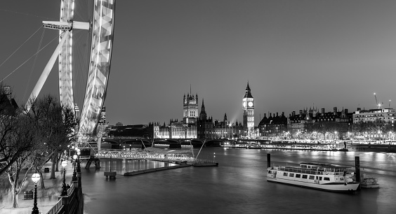 London, UK - April 7, 2017: Black and white artistic night photo of London Eye, Big Ben and Palace of Westminster aka Houses of parliament on 7th of April, 2017 in London, UK.