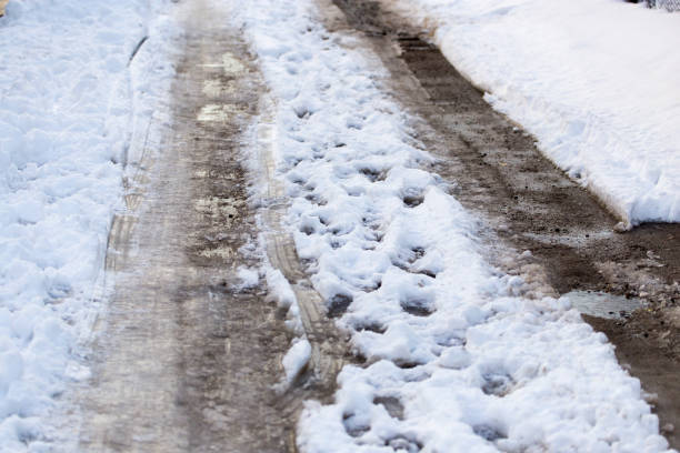 istock Snow with puddles on the road 678082014