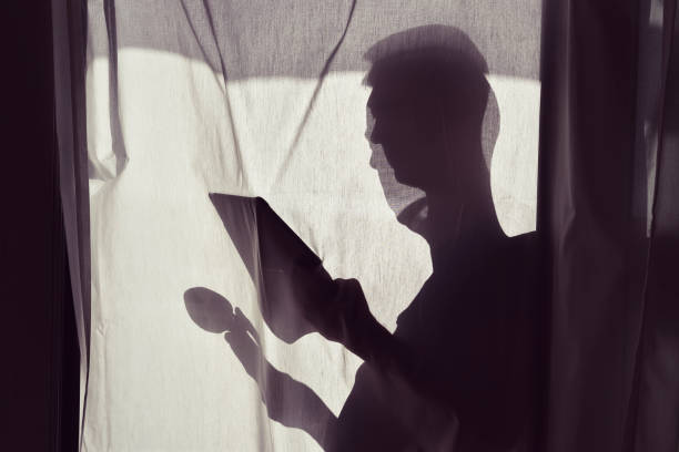 istock silhouette of man with caup and tablet 678103626