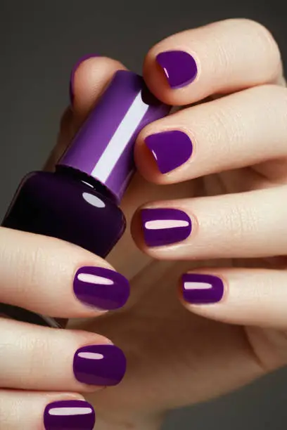 Bottle of nail polish. Beauty hands. Trendy stylish colorful nails, nailpolish. Great idea for the advertising of cosmetics. Beautiful manicuredl nails