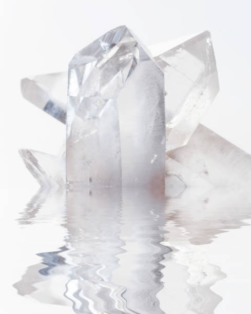 istock Transparent rock crystals on white reflected in a water 678110108