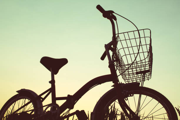 istock Silhouette of bicycle on grass with the sky sunset 678127124