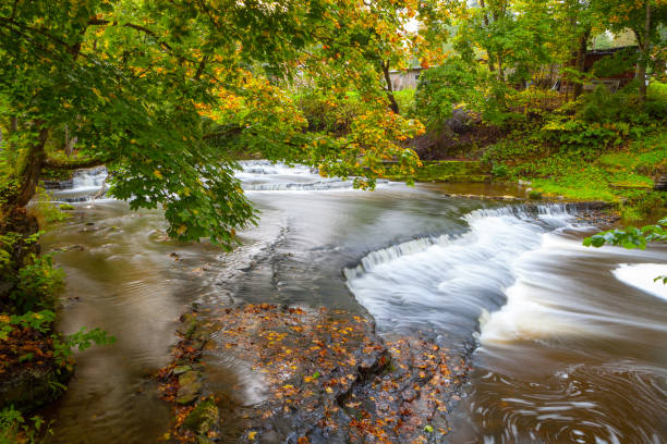 istock Joaveski waterfall on the river, with leaves, in Estonia 678127810