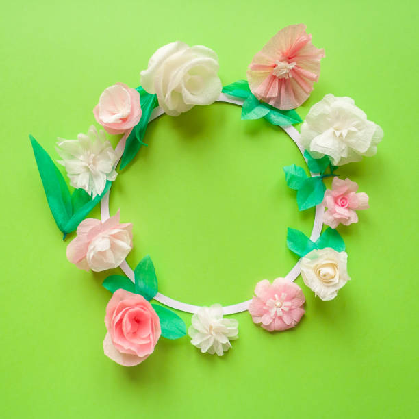 istock Round frame with color paper flower on green background. 678128922