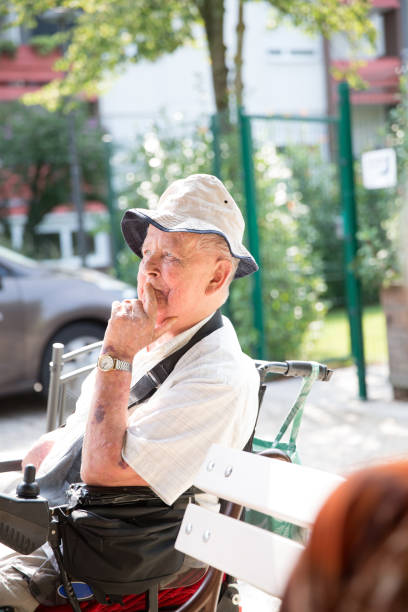 istock Senior Man Sitting on a Bench Outside 678130172