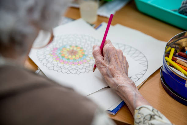 istock Senior Woman Coloring Mandala 678130486