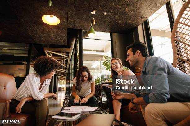 Team Of Corporate Professionals Having Friendly Discussion Stock Photo - Download Image Now