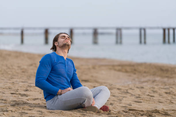 istock Handsome  man sitting alone at the beach 678131112