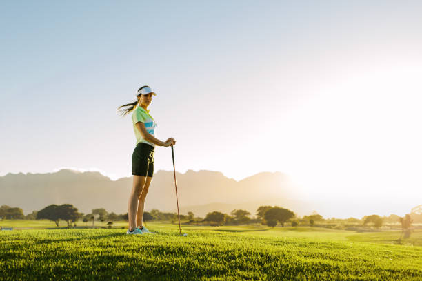 istock Female golfer standing on golf course 678131600