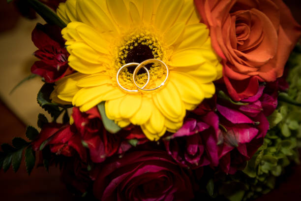 istock Wedding rings on flower bouquet. 678131808