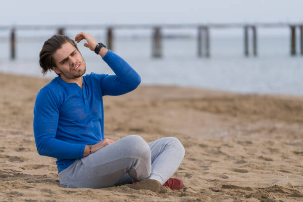 istock Handsome  man sitting alone at the beach 678131818