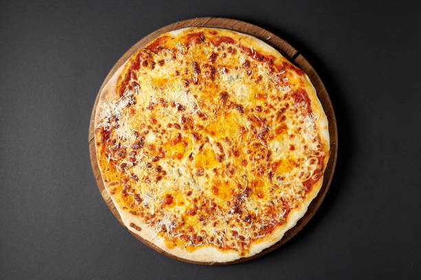 istock Hot pizza Quattro Formaggi on a rustic wooden table. 678132680