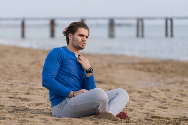 istock Handsome  man sitting alone at the beach 678133082
