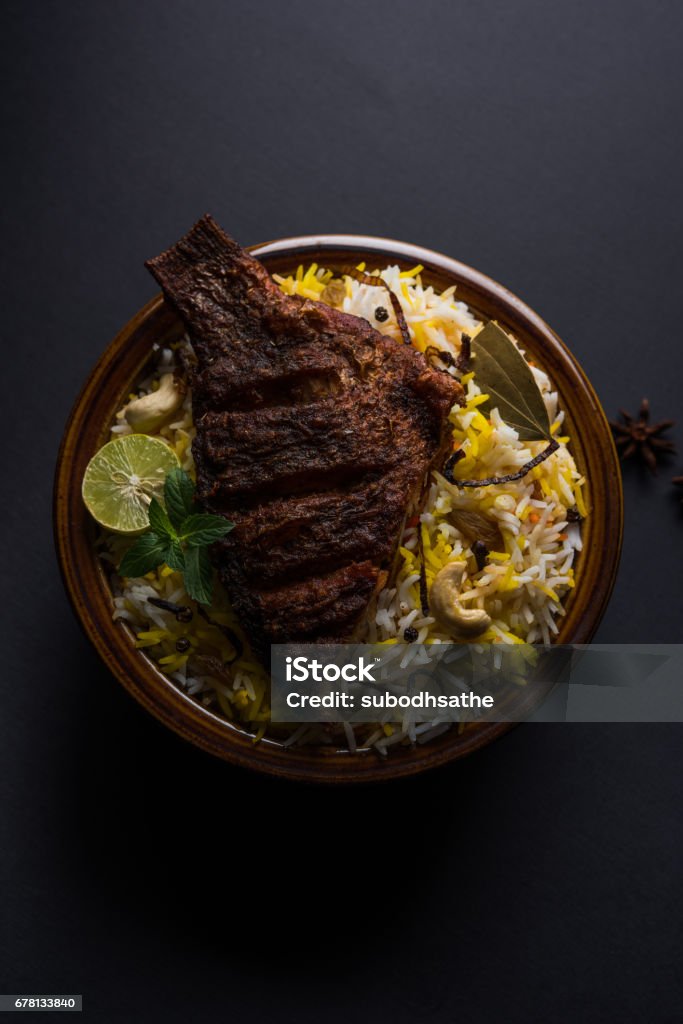 Fish Biryani or fish Rice - Popular Indian non-vegetarian recipe made of fish marinated with Indian spices fresh herbs and cooked with Basmati rice, selective focus Arab Culture Stock Photo
