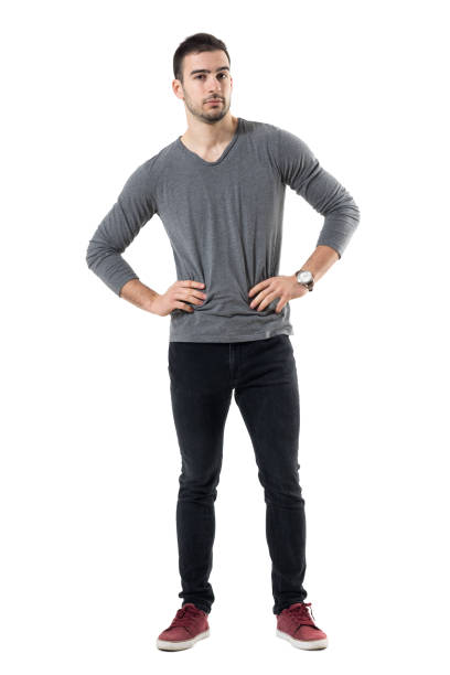 istock Serious young casual man with hands on waist looking at camera. 678134570