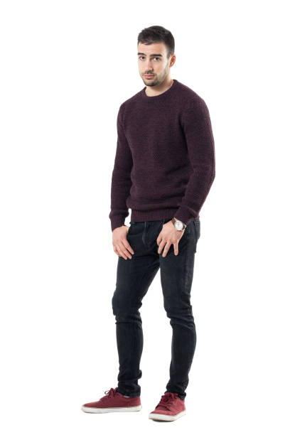 istock Sad young man with hands in pockets wearing sweater looking at camera. 678138494