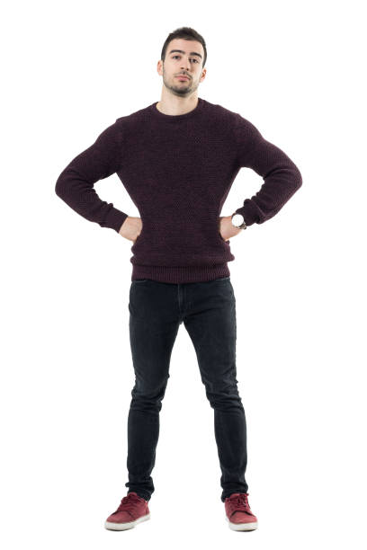 istock Serious young casual man with hands on waist looking at camera. 678144758