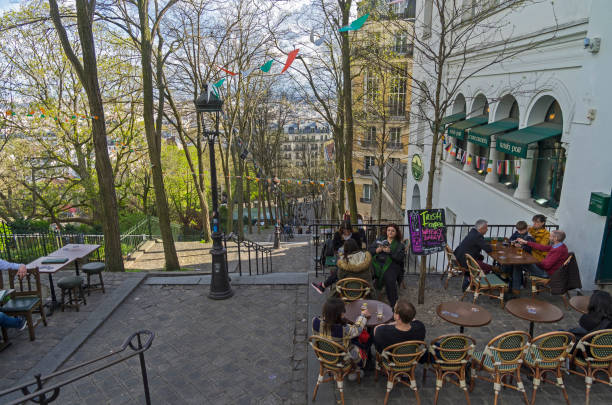 A small cafe on the stairs leading to the top of  Montmartre. Paris, France Paris: A small cafe (Irish pub) on the stairs leading to the top of the hill of Montmartre. Paris, France, early April, evening. irish punt note stock pictures, royalty-free photos & images