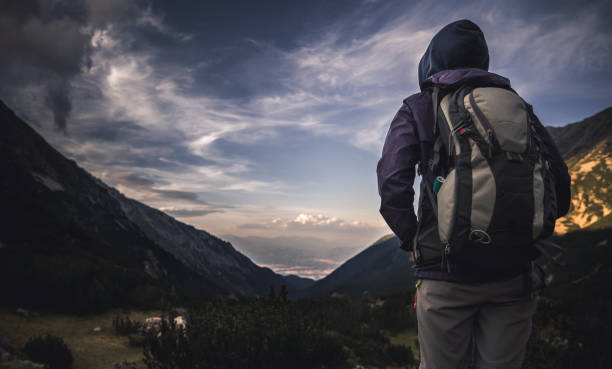 istock Traveler watching the sunset over the mountains 678181740