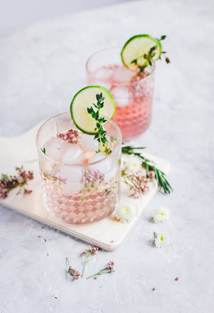 istock making cocktails in glasses with lime and herbs on stone kitchen desk background 678219566