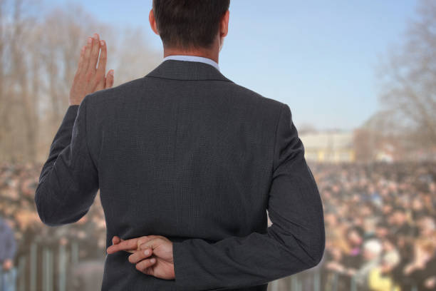 Politician liar gives people impossible promises with fingers crossed on his back. stock photo