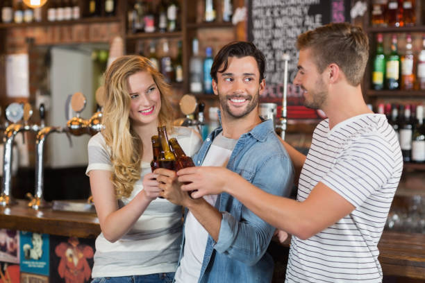 istock Cheerful friends toasting beer bottles at pub 678220522