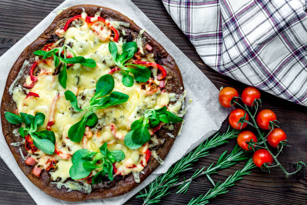 istock vegetarian pizza on wooden table background top view 678221372
