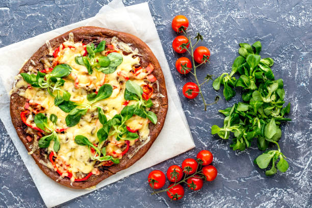 istock cooking pizza with vegetables and cheese on stone desk background top view 678221702