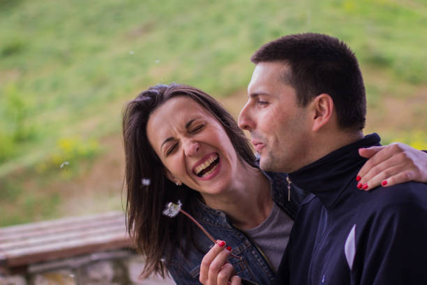 istock Young couple blowing dandelion 678255878