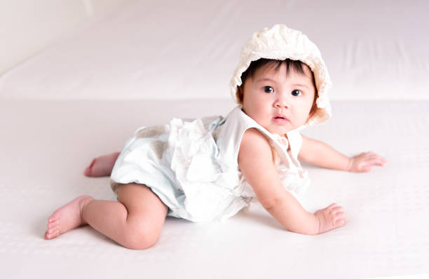 istock Asian girl 6 months old in bed 678257852
