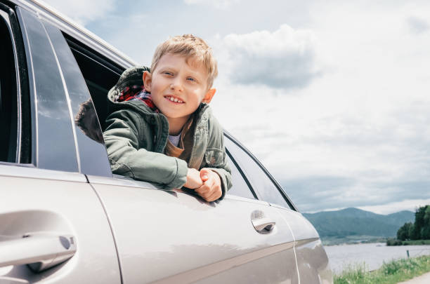 istock Boy looks out from car window 678259170