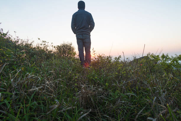 istock man standing in bush on mountain near sunset 678260034