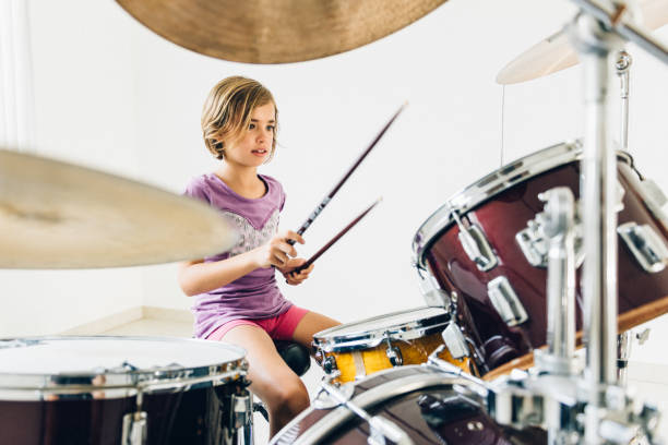 istock Little girl playing drums 678260528