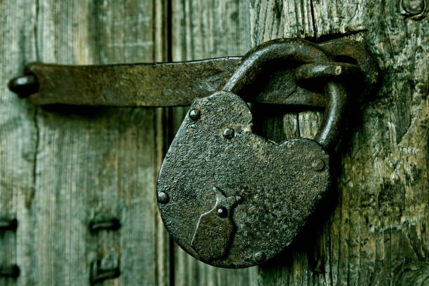 istock A rusty padlock on an old wooden door. 678270606