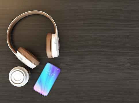 Wireless headphone and smart phone on dark wooden table. Copy space available. 3D rendering image.