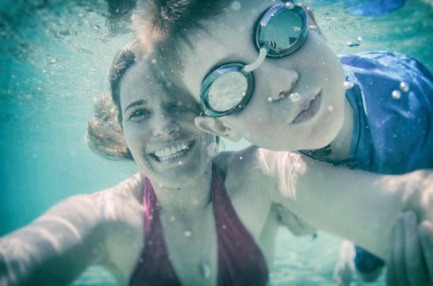 istock Mom and son with a goofy underwater selfie 678281162
