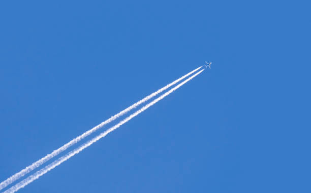istock Diagonal trace of plane flying in blue sky 678286670