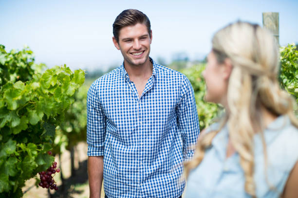 istock Smiling man looking at woman in vineyard 678344388