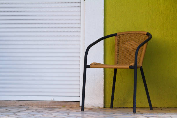 istock Chair against the wall with closed window. 678352640